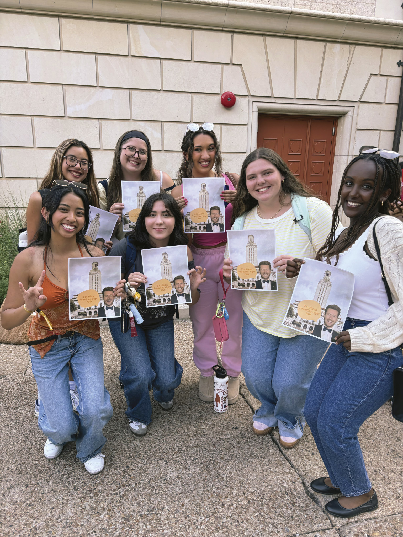 A group of fans wait to see Glen Powell.