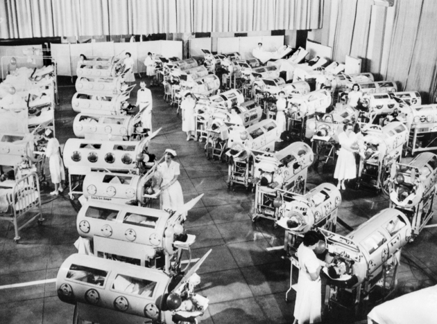 Nurse attend to a room full of polio patients in iron lung respirators. Rancho Los Amigos Respirator Center, Hondo, California.