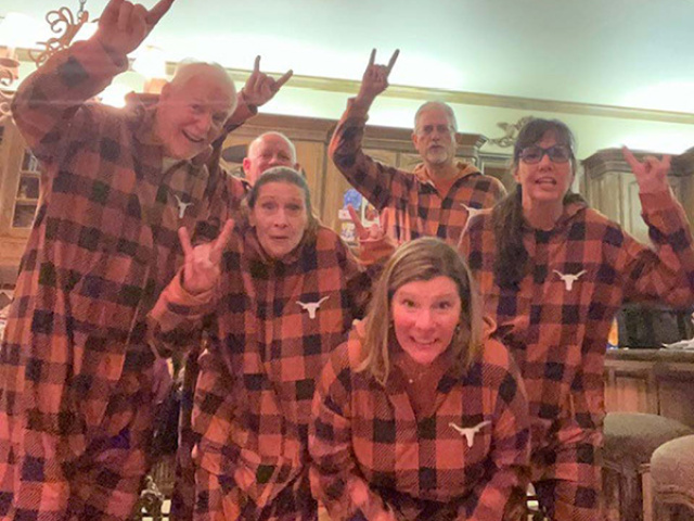 Longhorn family in burnt-orange plaid pajamas.
