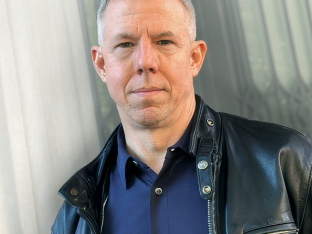 Author Michael Joseph Gross poses against a wall