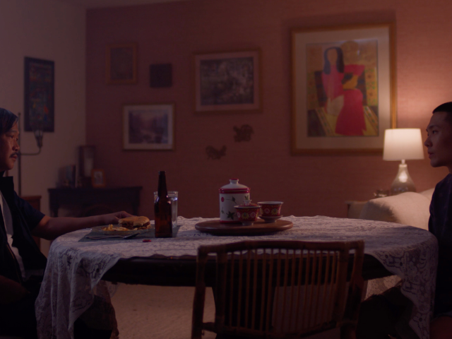 A father and son sitting a dinner table together