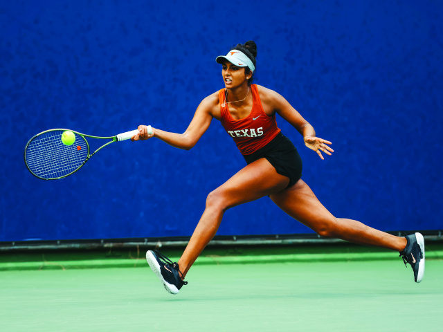 Malaika Rapolou, former Longhorn tennis player, hits tennis ball.