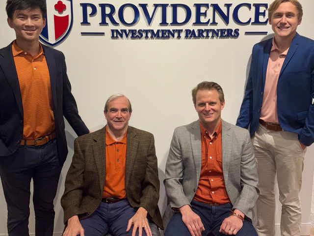 The staff at Providence Investment Partners pose for a photo. 