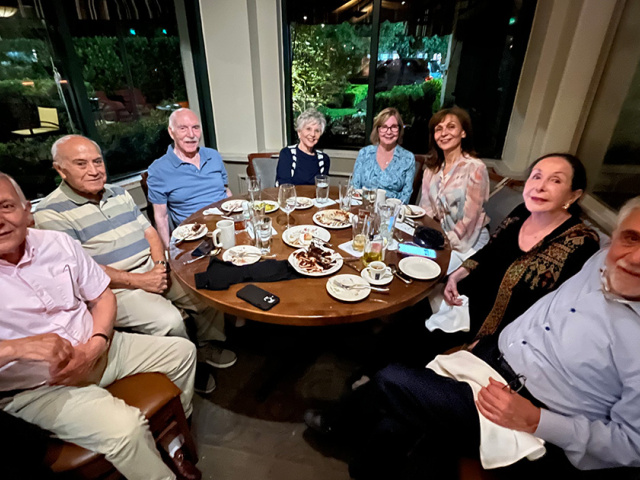 A group of friends sit around the table for dinner