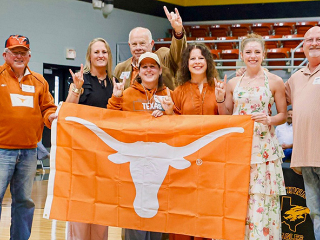Texas Alumni in Mills County hold burnt orange UT Flag