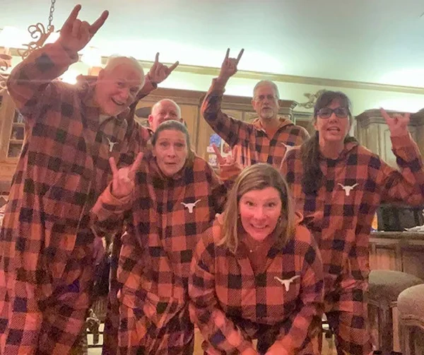 Longhorn family in burnt-orange plaid pajamas.