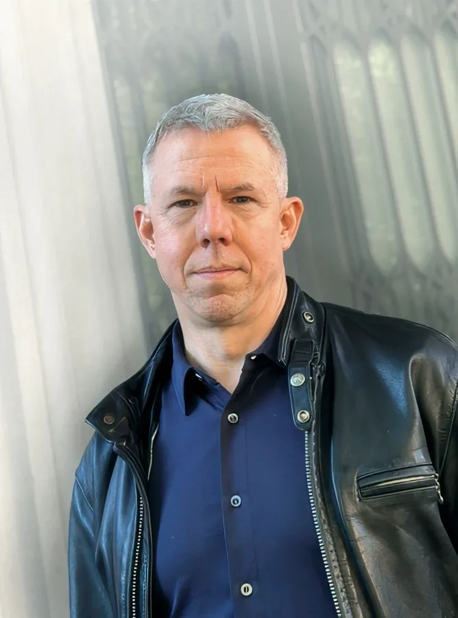 Author Michael Joseph Gross poses against a wall